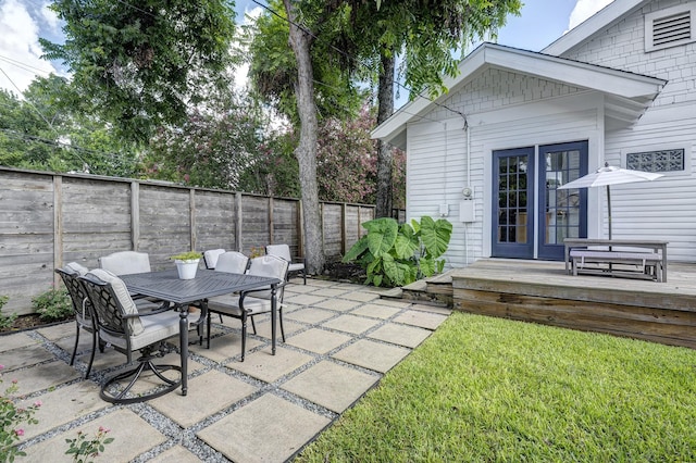 936 W Temple St, Houston, TX 77009 - fenced backyard featuring outdoor dining area, french doors, a patio area, and a wooden deck