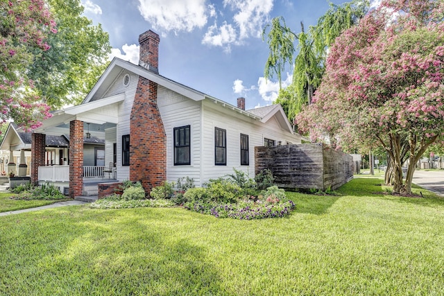 936 W Temple St, Houston, TX 77009 - view of side of property featuring a chimney, a porch, and a lawn