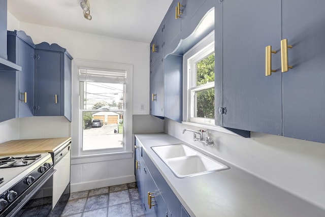 936 W Temple St, Houston, TX 77009 - kitchen with blue cabinetry, light stone finish flooring, white gas range, and light countertops