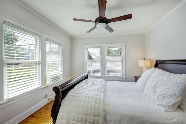 936 W Temple St, Houston, TX 77009 - bedroom with a textured ceiling, crown molding, wood finished floors, and ceiling fan