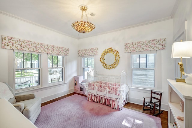 936 W Temple St, Houston, TX 77009 - bedroom featuring dark wood-type flooring, a chandelier, and ornamental molding