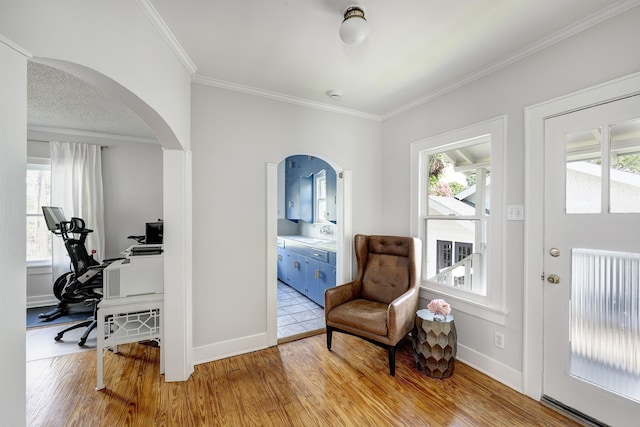 936 W Temple St, Houston, TX 77009 - living area featuring arched walkways, wood finished floors, a desk, and crown molding