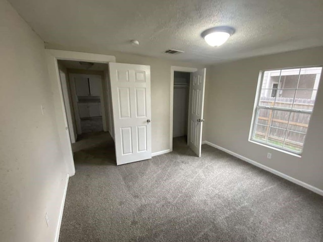 223 Cockerel St, Houston, TX 77018 - unfurnished bedroom with carpet flooring, a textured ceiling, and a closet