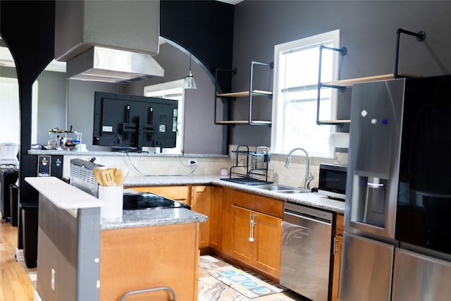 8309 Williamsdell St, Houston, TX 77088 - kitchen with stainless steel appliances, open shelves, arched walkways, tasteful backsplash, and brown cabinets
