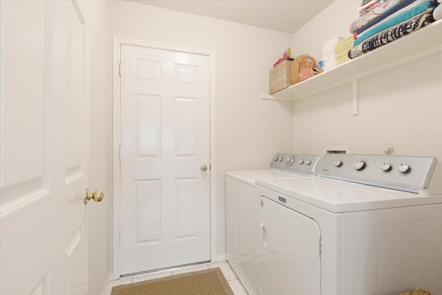 2210 Elm Forest Dr, Pearland, TX 77584 - laundry area with washing machine and clothes dryer and light tile patterned floors