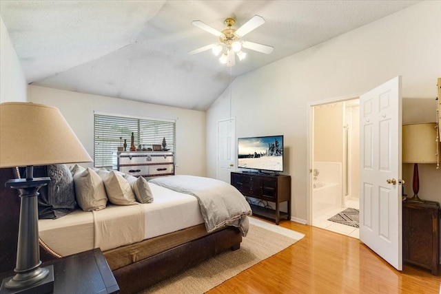 2210 Elm Forest Dr, Pearland, TX 77584 - bedroom with vaulted ceiling, light wood-style floors, ensuite bath, and a ceiling fan