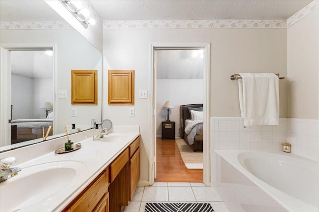 2210 Elm Forest Dr, Pearland, TX 77584 - ensuite bathroom featuring a garden tub, double vanity, and tile patterned flooring