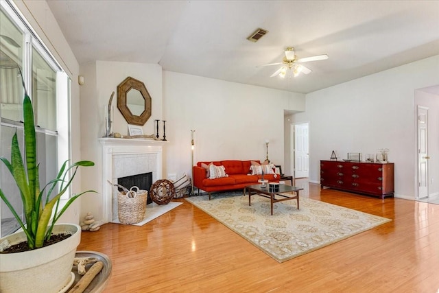 2210 Elm Forest Dr, Pearland, TX 77584 - living area with wood finished floors, ceiling fan, a tile fireplace, and baseboard heating