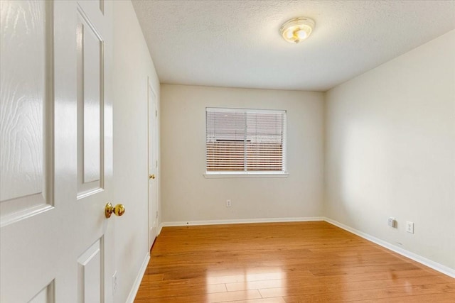2210 Elm Forest Dr, Pearland, TX 77584 - spare room featuring light wood-style floors and a textured ceiling