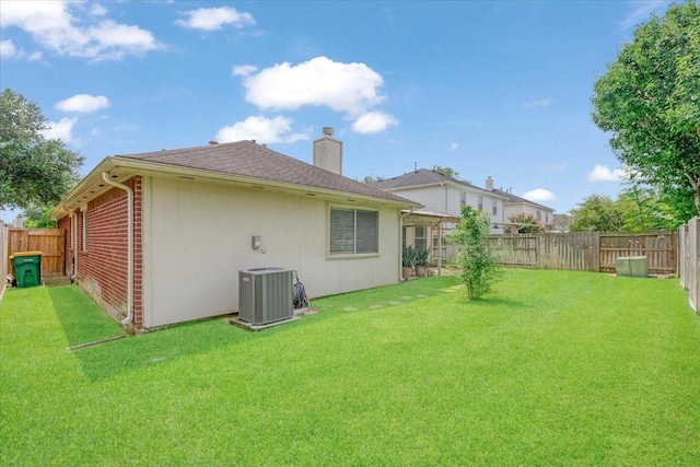 2210 Elm Forest Dr, Pearland, TX 77584 - back of property featuring a chimney, a fenced backyard, brick siding, and roof with shingles