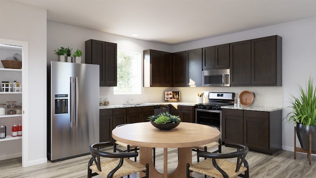 13328 Burbot Dr, Conroe, TX 77384 - kitchen featuring stainless steel appliances, light wood-style floors, dark brown cabinets, and recessed lighting