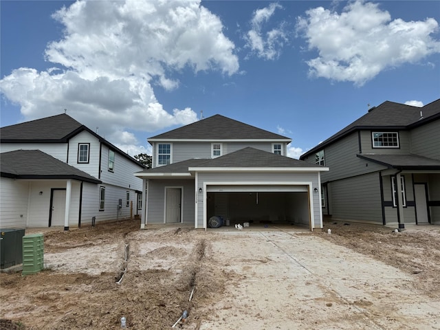 13336 Burbot Dr, Conroe, TX 77384 - traditional-style house featuring an attached garage, driveway, and a shingled roof