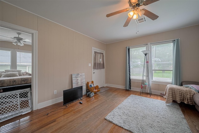 604 Abell St, Wharton, TX 77488 - living room with a ceiling fan, healthy amount of natural light, wood finished floors, and ornamental molding