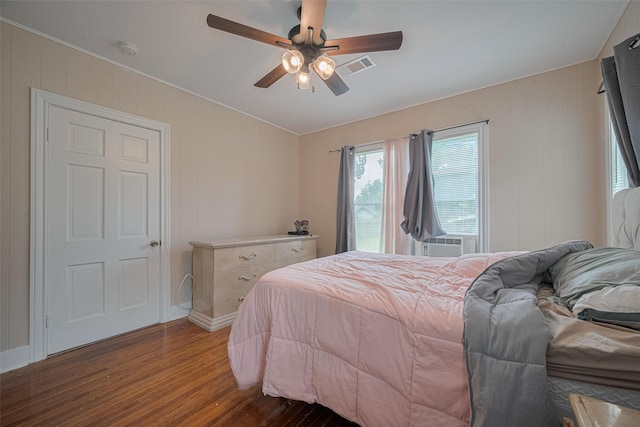 604 Abell St, Wharton, TX 77488 - bedroom with dark wood-style flooring, cooling unit, and a ceiling fan