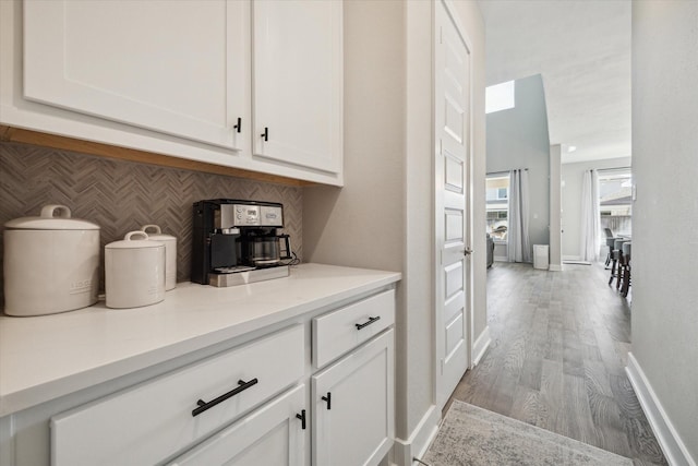 19526 Rock Quillwort Rd, Cypress, TX 77433 - bar featuring backsplash and wood finished floors