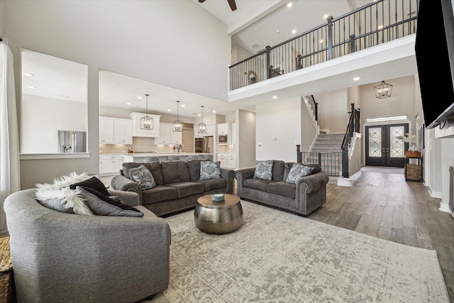 19526 Rock Quillwort Rd, Cypress, TX 77433 - living room featuring a high ceiling, wood finished floors, stairs, ceiling fan, and recessed lighting