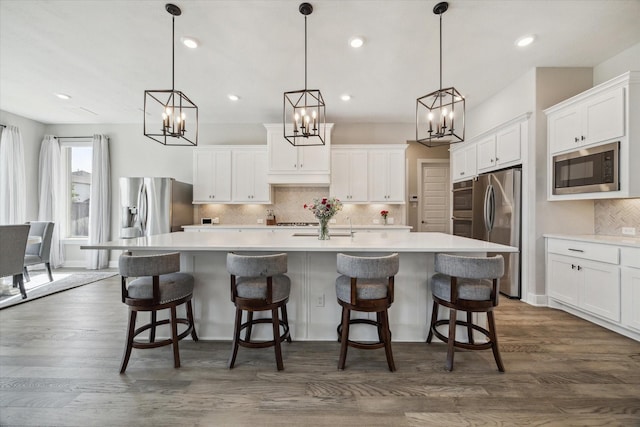 19526 Rock Quillwort Rd, Cypress, TX 77433 - kitchen with appliances with stainless steel finishes, a chandelier, tasteful backsplash, a large island, and recessed lighting