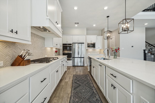 19526 Rock Quillwort Rd, Cypress, TX 77433 - kitchen with appliances with stainless steel finishes, backsplash, white cabinets, light countertops, and dark wood-style flooring