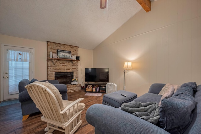 2017 Willow Bend Rd, Wharton, TX 77488 - living area with dark wood-style flooring, a ceiling fan, a fireplace, and a textured ceiling