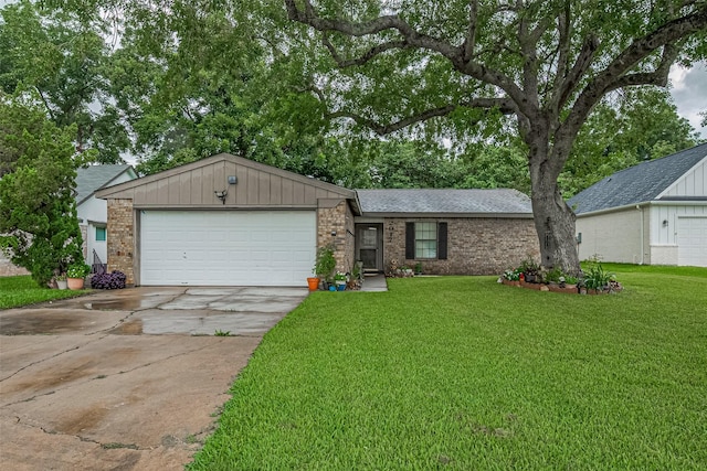 2017 Willow Bend Rd, Wharton, TX 77488 - view of front facade with a garage, driveway, a front yard, and brick siding