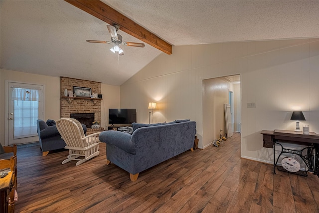 2017 Willow Bend Rd, Wharton, TX 77488 - living area featuring wood finished floors, a ceiling fan, a textured ceiling, a brick fireplace, and attic access