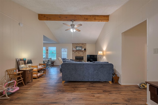 2017 Willow Bend Rd, Wharton, TX 77488 - living area featuring dark wood-style floors, a ceiling fan, a brick fireplace, and a textured ceiling