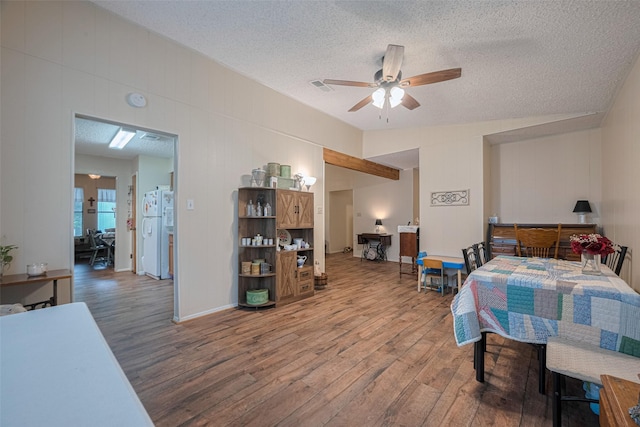 2017 Willow Bend Rd, Wharton, TX 77488 - bedroom featuring freestanding refrigerator, wood finished floors, and a textured ceiling