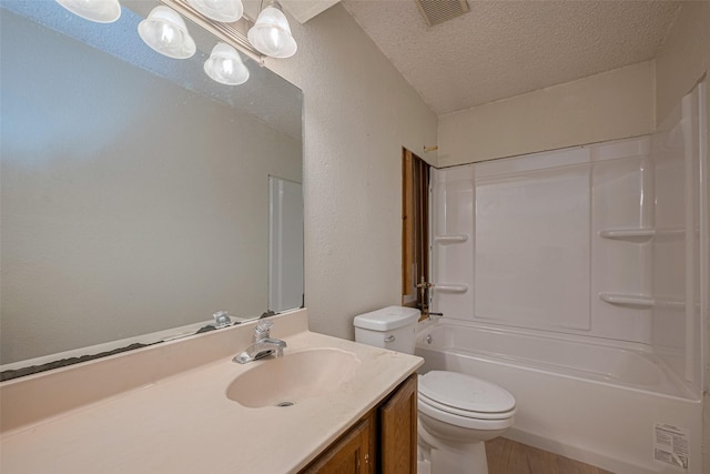 2017 Willow Bend Rd, Wharton, TX 77488 - bathroom featuring vanity, a textured ceiling, tub / shower combination, wood finished floors, and a textured wall
