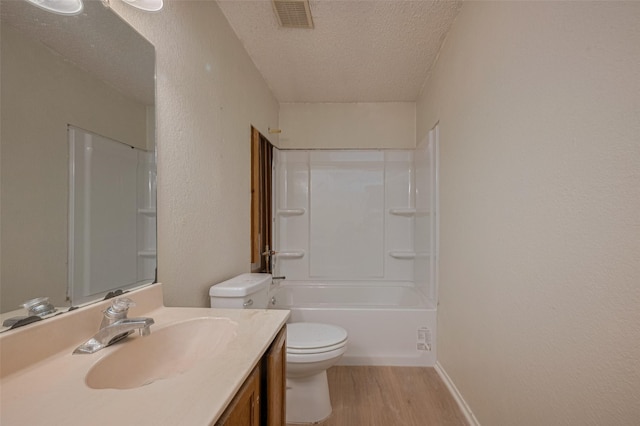 2017 Willow Bend Rd, Wharton, TX 77488 - bathroom featuring a textured ceiling, wood finished floors, vanity, a textured wall, and shower / tub combination