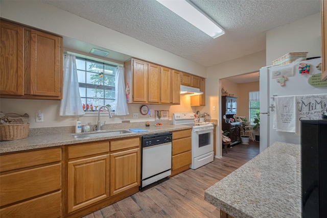 2017 Willow Bend Rd, Wharton, TX 77488 - kitchen featuring white appliances, under cabinet range hood, light wood finished floors, light countertops, and a textured ceiling