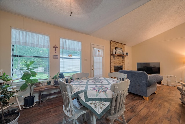 2017 Willow Bend Rd, Wharton, TX 77488 - dining space featuring hardwood / wood-style flooring, lofted ceiling, a textured ceiling, and a fireplace
