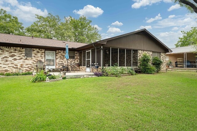 860 Helter St, La Grange, TX 78945 - rear view of property with brick siding, a patio area, a yard, and a sunroom