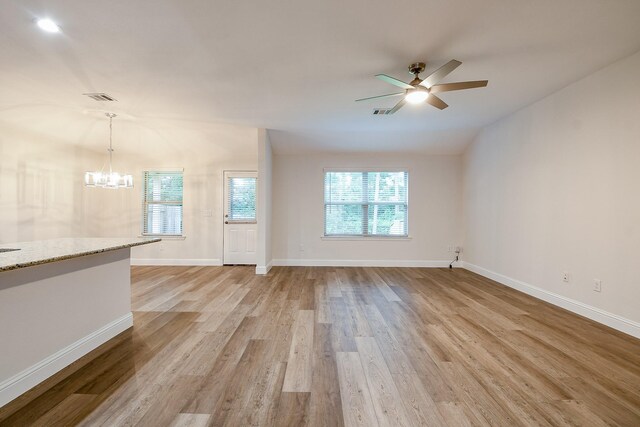 167 Courageous Side Way, Magnolia, TX 77354 - unfurnished living room with light wood finished floors, a chandelier, a ceiling fan, and vaulted ceiling