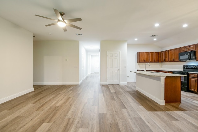 167 Courageous Side Way, Magnolia, TX 77354 - kitchen with black appliances, light countertops, ceiling fan, light wood-type flooring, and an island with sink