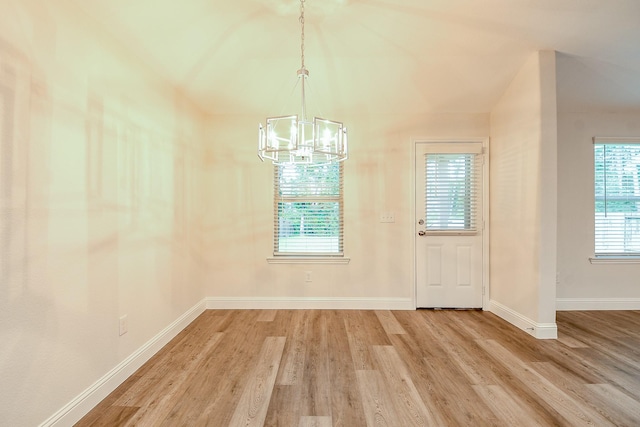 167 Courageous Side Way, Magnolia, TX 77354 - unfurnished dining area with a chandelier and light wood-style floors