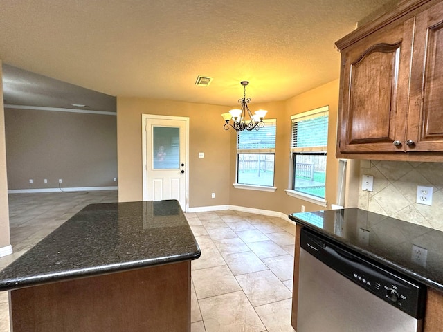 1040 Cardinal Dr, Richwood, TX 77566 - kitchen featuring stainless steel dishwasher, decorative backsplash, a chandelier, dark stone countertops, and light tile patterned floors