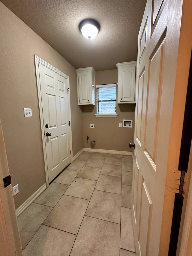 1040 Cardinal Dr, Richwood, TX 77566 - washroom with hookup for an electric dryer, a textured ceiling, cabinet space, and washer hookup