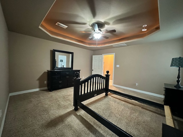 1040 Cardinal Dr, Richwood, TX 77566 - carpeted bedroom with a raised ceiling and a ceiling fan