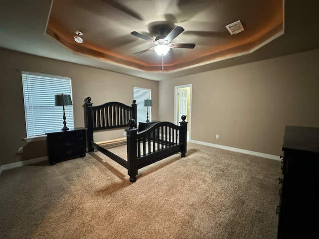 1040 Cardinal Dr, Richwood, TX 77566 - bedroom featuring a tray ceiling, carpet, and a ceiling fan