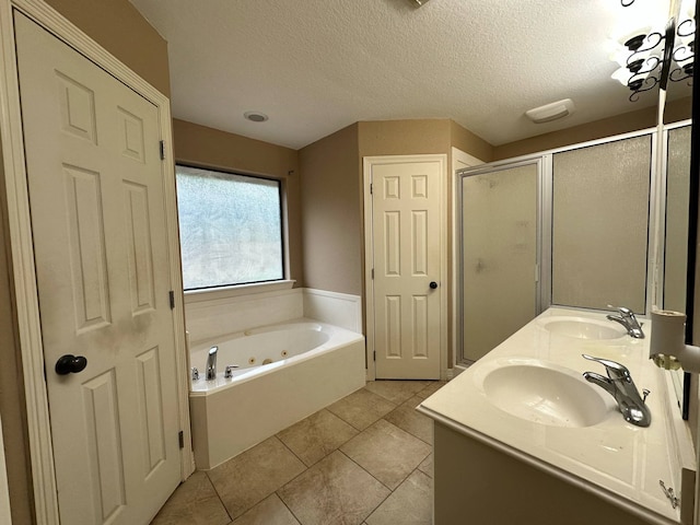 1040 Cardinal Dr, Richwood, TX 77566 - full bath featuring a whirlpool tub, a shower stall, double vanity, tile patterned floors, and a textured ceiling