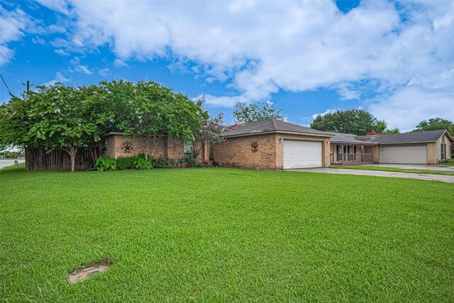 1805 Willow Bend Rd, Wharton, TX 77488 - view of front of house featuring a garage, concrete driveway, and brick siding