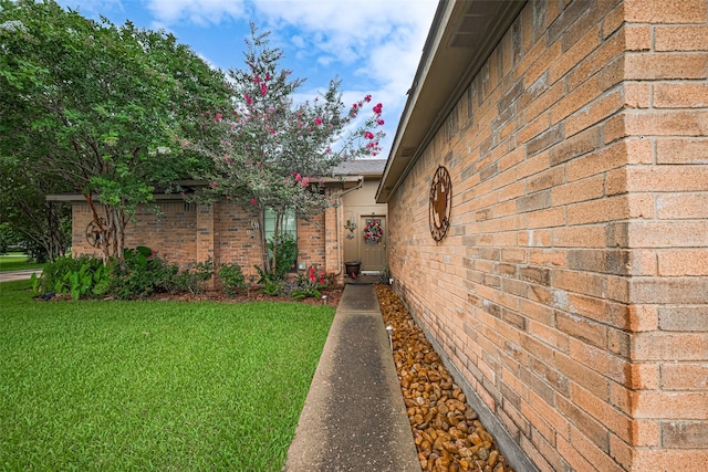 1805 Willow Bend Rd, Wharton, TX 77488 - view of side of home featuring brick siding and a yard
