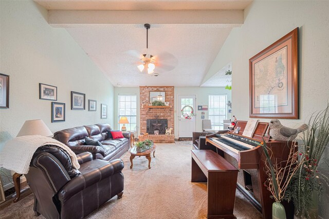 1805 Willow Bend Rd, Wharton, TX 77488 - living room with light colored carpet, ceiling fan, beam ceiling, a fireplace, and high vaulted ceiling