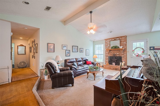 1805 Willow Bend Rd, Wharton, TX 77488 - living room featuring hardwood / wood-style floors, ceiling fan, a textured ceiling, and a fireplace
