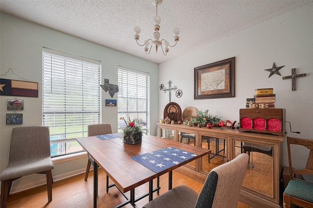 1805 Willow Bend Rd, Wharton, TX 77488 - dining room featuring a textured wall, a chandelier, a textured ceiling, and light wood-style floors