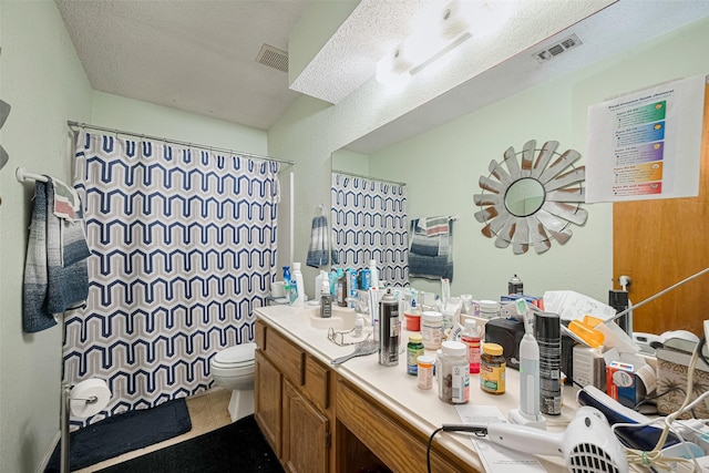 1805 Willow Bend Rd, Wharton, TX 77488 - full bath featuring double vanity, a shower with shower curtain, tile patterned flooring, and a textured ceiling