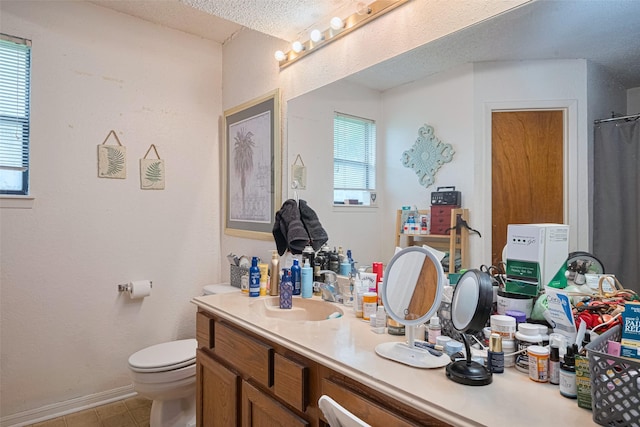 1805 Willow Bend Rd, Wharton, TX 77488 - bathroom featuring double vanity, tile patterned floors, a textured ceiling, and a shower with shower curtain