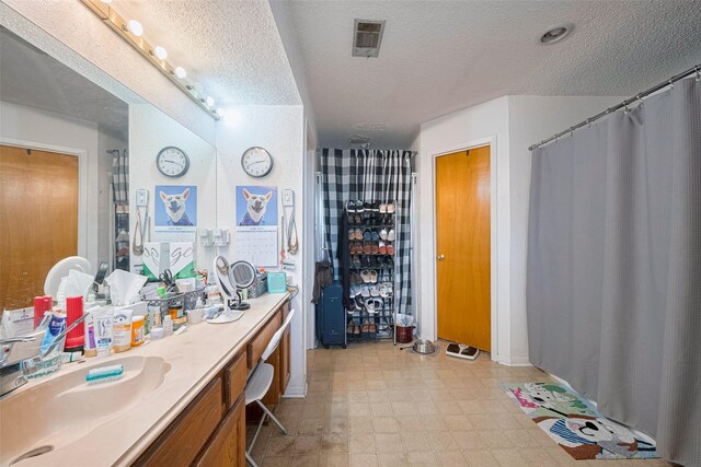 1805 Willow Bend Rd, Wharton, TX 77488 - bathroom with a textured ceiling, vanity, a shower with curtain, and tile patterned floors