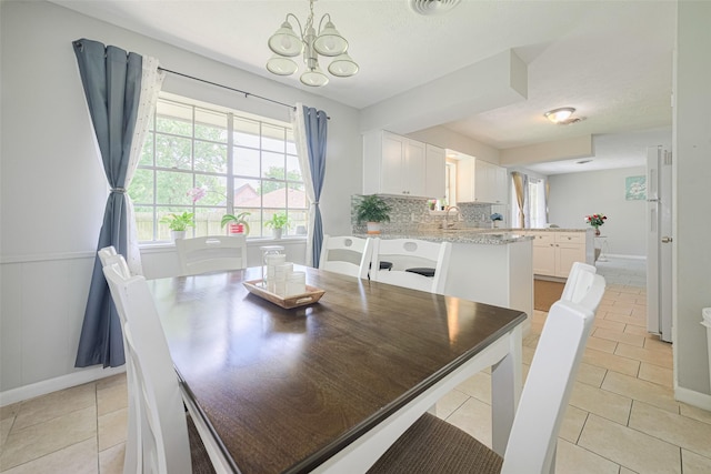 101 Wildrose St, Baytown, TX 77520 - dining area featuring a chandelier and light tile patterned flooring