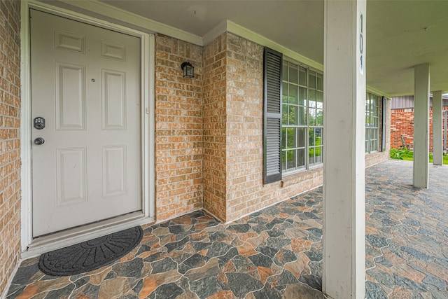 101 Wildrose St, Baytown, TX 77520 - view of exterior entry featuring a porch and brick siding